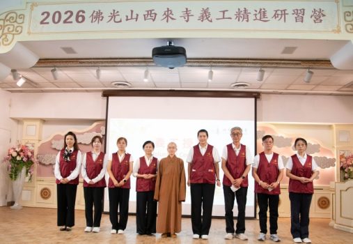 西來寺二單監院知行法師(中)為完成50小時服務及通過考核的23位實習義工授證。