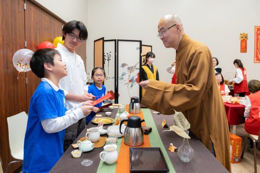慧東法師(右)發放紅包予現場每一位教師及小小茶師。