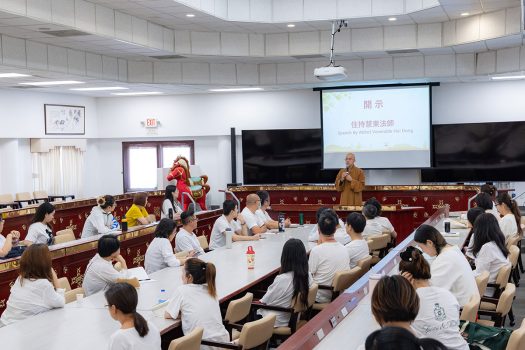 新進義工認真聆聽慧東法師開示。